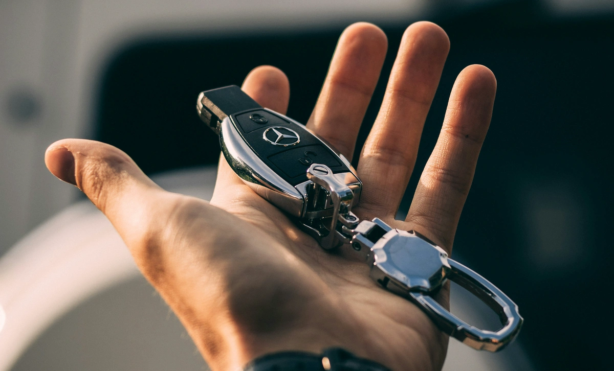 A hand holding car keys