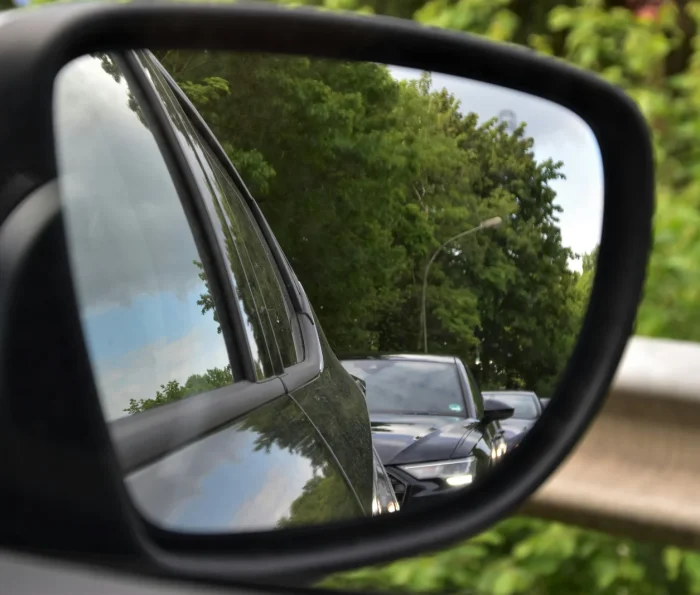 Cars reflected in a wing mirror.