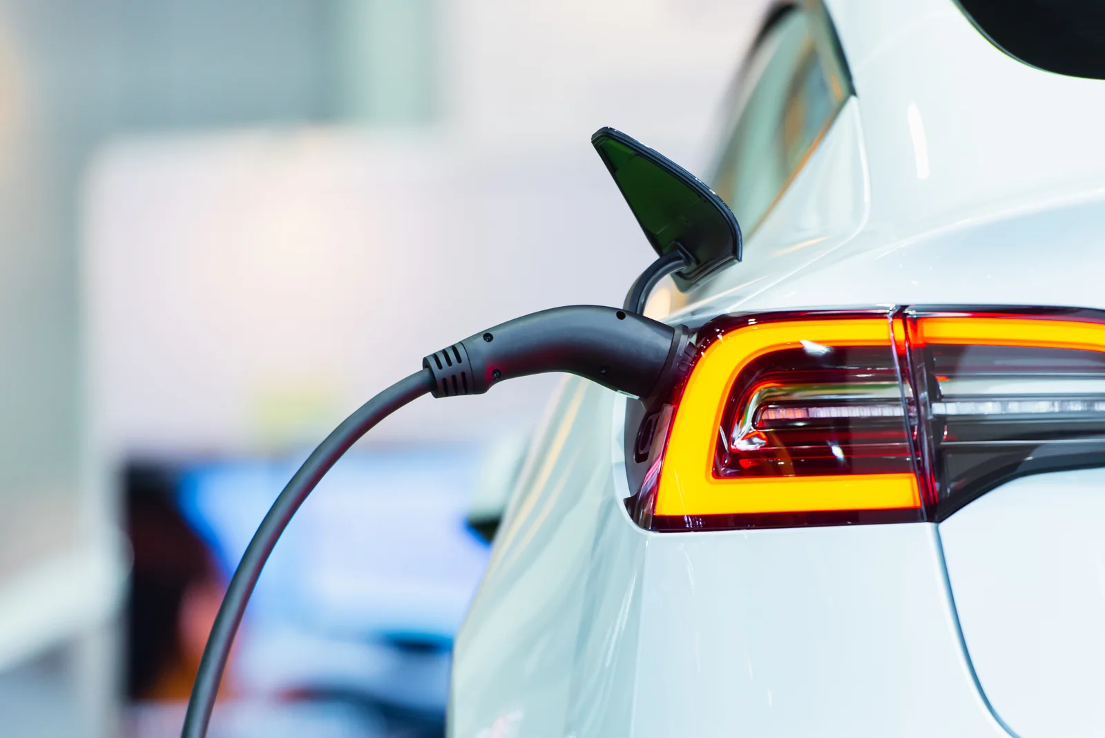 Electric car connected to a charging cable.