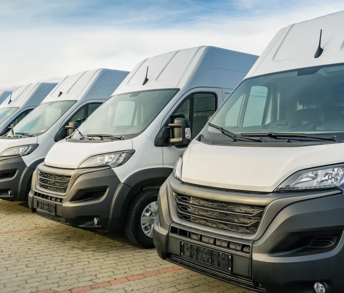 Row of white fleet vans parked together